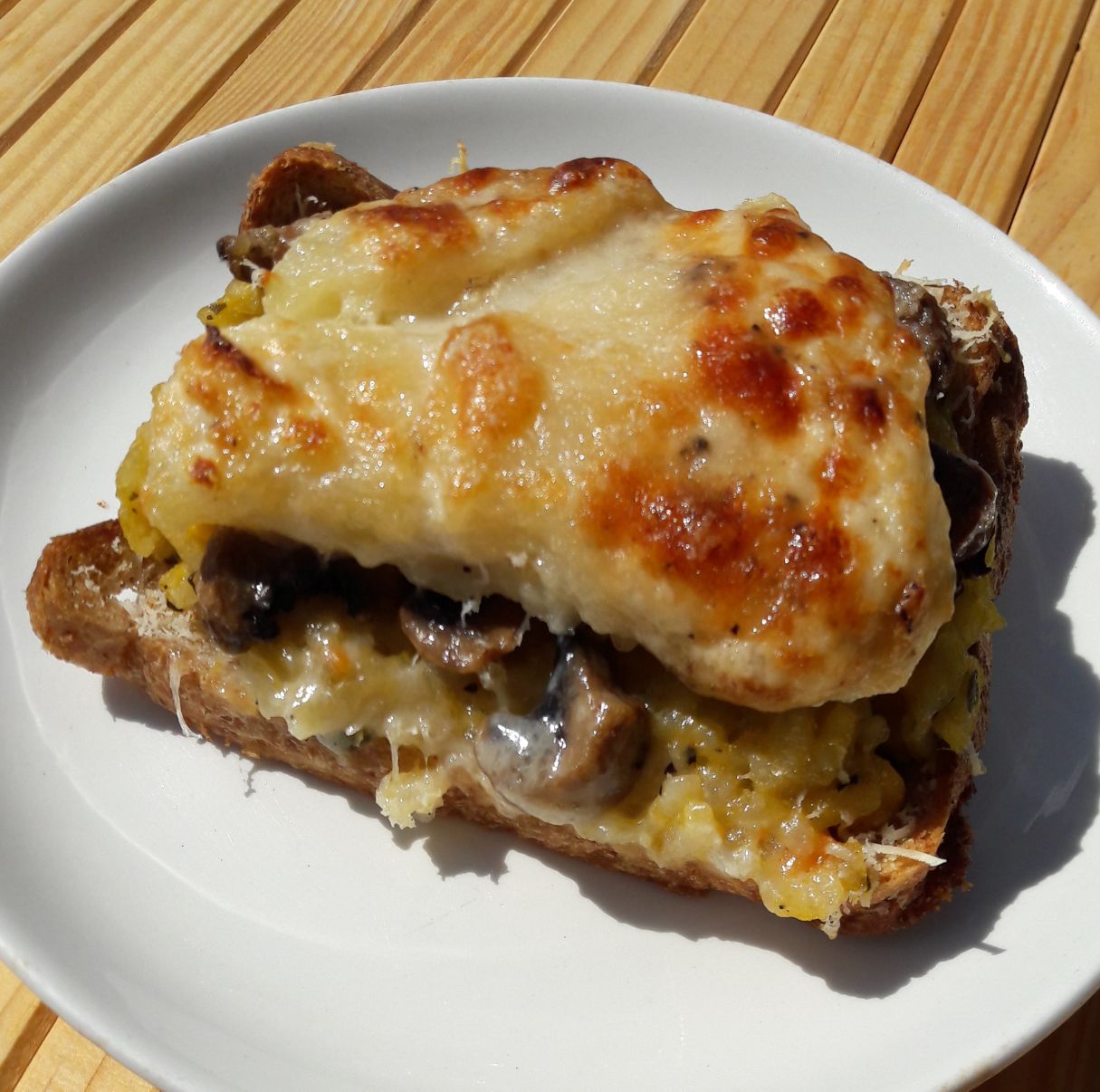 Vegetables risotto topped with baked potato on toasted bread