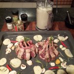 Place lamb (straight rack or turned in on itself as in picture) amongst rosemary, garlic, chilli and slices of potato and mushroom. Drizzle with olive oil and salt & pepper. Place in oven (at 180degrees C for 20-25min)