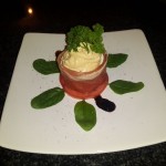 4.	Top the little tower with hummus and finish with a few leaves of parsley and a touch of reduction