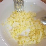 Using a fork semi mash the boiled egg;