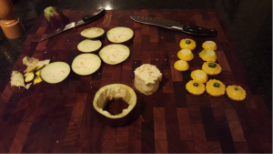 4.	Slice the patty pans into half, and aubergine into disks. Note the hollowed out ¼ length aubergine disk;