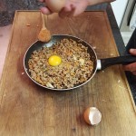 5. Once the mince is cooked, take off the stove and break the eggs in, and mix through;