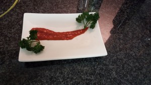 8.	Spoon down some strawberry pure, plate the parcel and sprinkle with some chopped parsley;