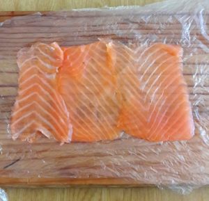 Lay the salmon slice on a plastic sheets