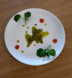 Garnish the plate whit pesto tomato and water cres